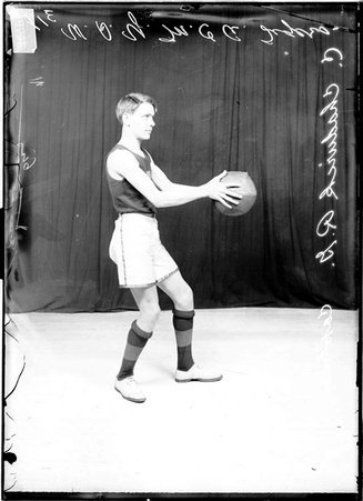 Basketball player, C. Chadwick, West Side YMCA, holding basketball in front - Chicago Daily News, Inc.