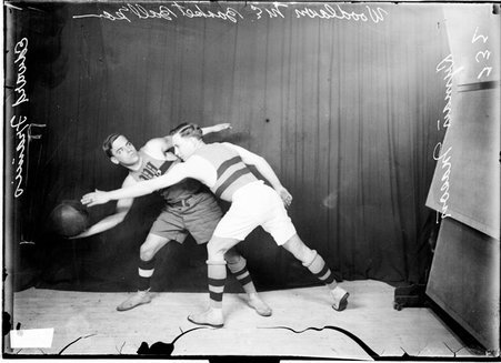 Basketball players, Edward Francis and Lyman Mason, Woodland Methodist Episcopal, Francis holding ball in front of dark background - Chicago Daily News, Inc.