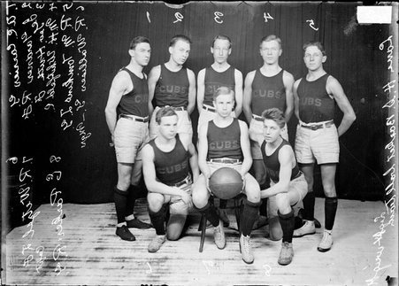 Lane High School basketball team players posing in front of a dark colored background - Chicago Daily News, Inc.