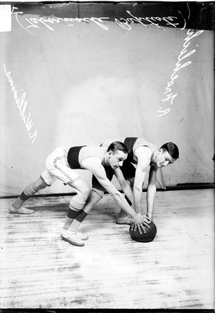 Tabernacle Baptist Church basketball players R. Froehlich and R. Williams posing in front of a light colored background - Chicago Daily News, Inc.
