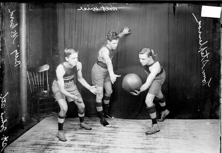 St. John's Athletic Club basketball players posing, Stevenson, guarded by Wise, holding the ball, McCord reaching for the pass - Chicago Daily News, Inc.