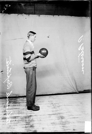 Tabernacle Baptist Church bowler P. Peterson holding a bowling ball standing with his right side to the camera in front of a light colored background - Chicago Daily News, Inc.