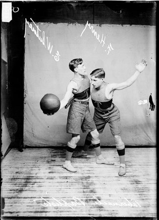 Tabernacle Baptist Church basketball players F. Henry and E. Whitney posing with Whitney holding the ball and Henry guarding him - Chicago Daily News, Inc.