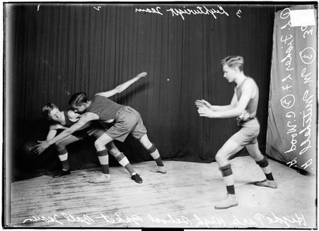 Hyde Park High School lightweight basketball players posing with Fisher, guarded by Wood, preparing to pass the ball to Mitchell - Chicago Daily News, Inc.