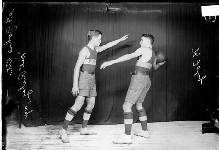 St. John's Athletic Club basketball players posing with Richey guarding Foley - Chicago Daily News, Inc.