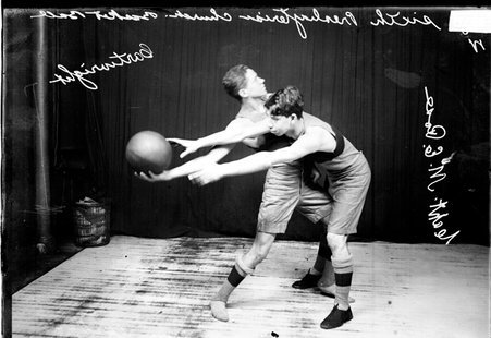Sixth Presbyterian Church basketball players posing with Cartwright holding the ball and Rose guarding him. - Chicago Daily News, Inc.