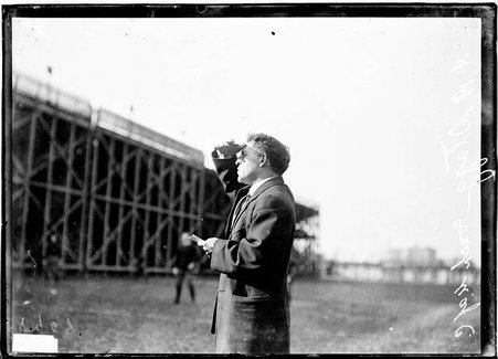 Football, Coach Alonzo A. Stagg standing at Marshall Field, looking left of image shading eyes, U. of C. - Chicago Daily News, Inc.