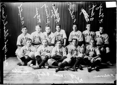 Crane High School indoor baseball team posing in front of a dark colored background - Chicago Daily News, Inc.