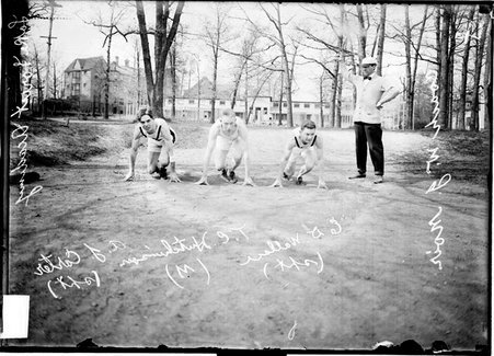 Lake Forest Academy athletes sprinter E. D. Wallace, one-mile runner T. C. Hutchinson and sprinter A. C. Carter crouching in set position - Chicago Daily News, Inc.