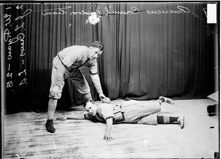 Americus Council indoor baseball players, Ryan tagging Crews, who lying on the floor, with the ball. - Chicago Daily News, Inc.