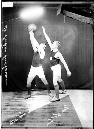 St. Luke's Lutheran Church basketball players, Schuette holding the ball above his head and Lebbin guarding him - Chicago Daily News, Inc.