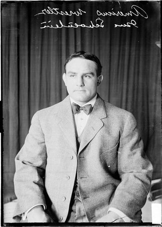 Americus wrestler Gus Schoenlein sitting in front of a dark colored background - Chicago Daily News, Inc.
