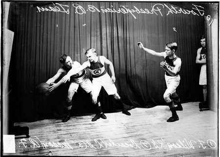 Fourth Presbyterian Church basketball players posing with Wilson, guarded by Loescher, preparing to pass the ball to Mason - Chicago Daily News, Inc.
