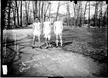 Lake Forest Academy athletes E. N. Benson (one mile), D. C. Thwing (half-mile) and A. C. Gluck (sprinter) standing on a dirt path outdoors - Chicago Daily News, Inc.