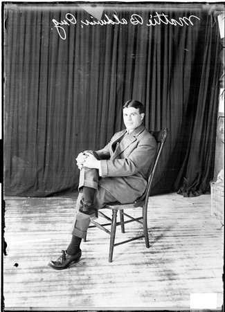 Pugilist, Matty Baldwin sitting and holding his right knee crossed over his left leg - Chicago Daily News, Inc.