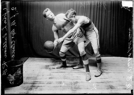 First Methodist Episcopal Church basketball players posing Sullivan holding the ball and McClane guarding him - Chicago Daily News, Inc.