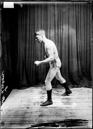 Pugilist, Chuck Larson standing in boxing stance facing left of image - Chicago Daily News, Inc.