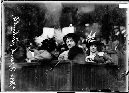 Mrs. Frank Schulte, wife of an athlete, sitting among spectators - Chicago Daily News, Inc.