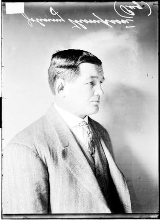 Boxer Johnny Thompson facing the right side of the image sitting in front of a light colored background - Chicago Daily News, Inc.