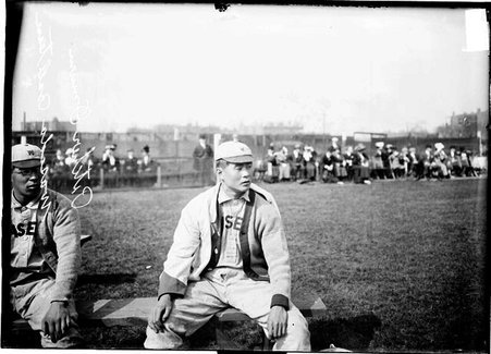 Baseball player, Omuru of Waseda University (Japan) sitting on the bench during game with University of Chicago - Chicago Daily News, Inc.
