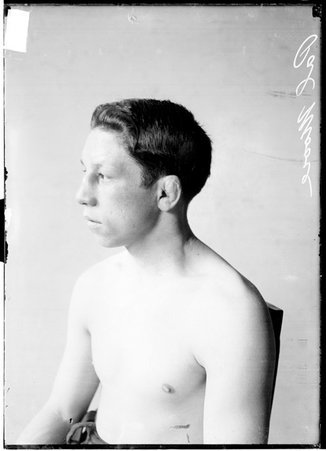 Pugilist, Pal Moore, sitting in profile in front of a light-colored backdrop - Chicago Daily News, Inc.