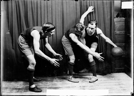 Basketball players, W. Thomsen, J. Rick, and G. Kuhnen, St. Paul's, posing with one passing to another player as the third blocks - Chicago Daily News, Inc.