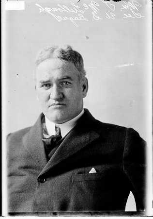U. S. League secretary, William T. McLullough, sitting in front of a light colored background - Chicago Daily News, Inc.