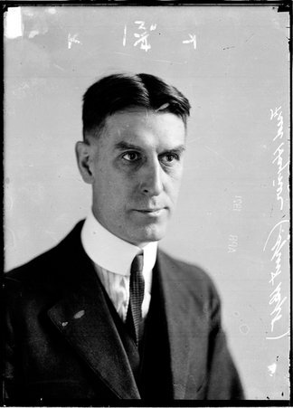 Fred Hayner, left shoulder back, looking slightly to image right, sitting in front of a light-colored backdrop - Chicago Daily News, Inc.