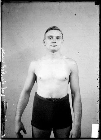 Wrestler, Dick Hankel, standing in front of a light-colored backdrop - Chicago Daily News, Inc.