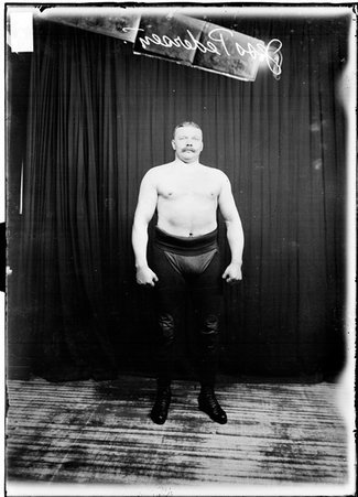 Wrestler, Jess Pedersen with his arms at his sides - Chicago Daily News, Inc.