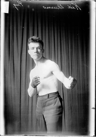 Pugilist, Kid Burne, standing in a boxing stance facing the camera - Chicago Daily News, Inc.