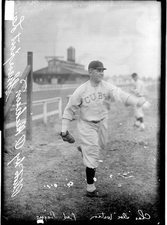 Baseball player, Doc Watson, Chicago Whales, posing in throwing stance by a racetrack fence - Chicago Daily News, Inc.