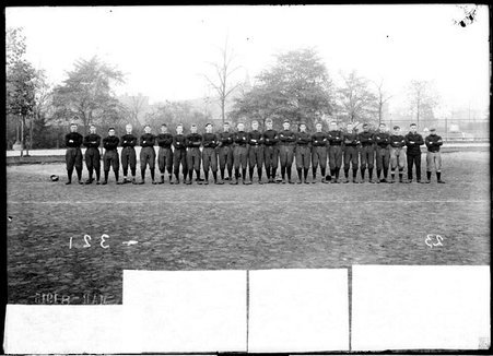 Football team, Wendell Phillips High School football team, standing shoulder to shoulder on an athletic field - Chicago Daily News, Inc.