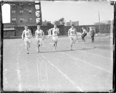 Athletes Harvey Blair, George Smith, Vickery, and Malcomson racing on an athletic track - Chicago Daily News, Inc.