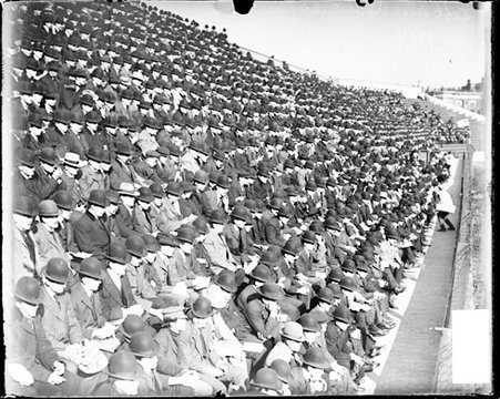 Crowd sitting in the bleachers at Marshall Field on University of Chicago campus in the Hyde Park community area, viewed at an angle - Chicago Daily News, Inc.