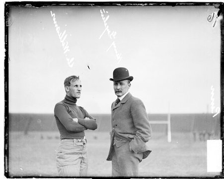 Pennsylvania football coach Williams standing with Harry Geyelin on an athletic field - Chicago Daily News, Inc.