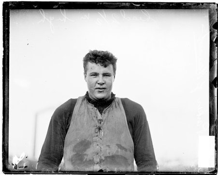 Harvard University football player, Parker, standing outdoors - Chicago Daily News, Inc.