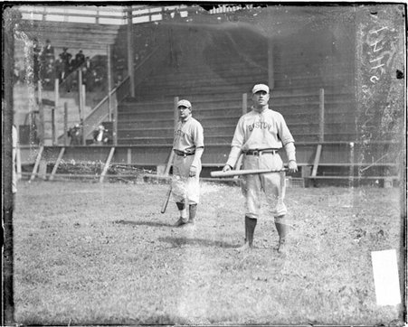 Boston Pilgrims baseball player, H. Ferris, holding a bat, standing in front of the grandstands at South Side Park - Chicago Daily News, Inc.