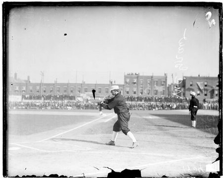 New York National League Superbas baseball player, John McGraw, swinging a bat while warming up, standing near home plate - Chicago Daily News, Inc.