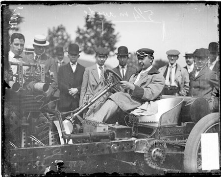 Automobile driver, Barney Oldfield, sitting in the driver's seat of an automobile, holding on to the steering wheel - Chicago Daily News, Inc.