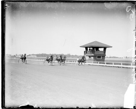 Horses harnessed to carriages racing on a racetrack in Libertyville, Illinois - Chicago Daily News, Inc.