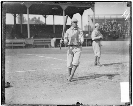Boston National League Beaneaters baseball player, John O'Neil, holding a bat with one hand and tossing a baseball with the other hand - Chicago Daily News, Inc.