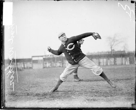 Fred Walker, coach of the University of Chicago baseball team, cocking his arm to throw a baseball - Chicago Daily News, Inc.