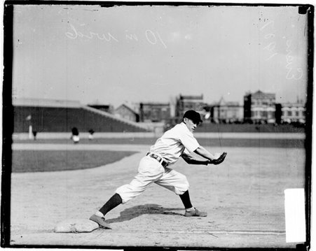 Baseball player Johnny Evers, Chicago Cubs, pounding his baseball glove with his right hand, at West Side Grounds - Chicago Daily News, Inc.