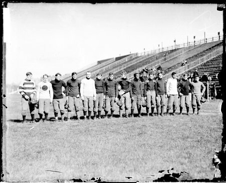 Members of the Wendell Phillips High School football team standing on an athletic field - Chicago Daily News, Inc.