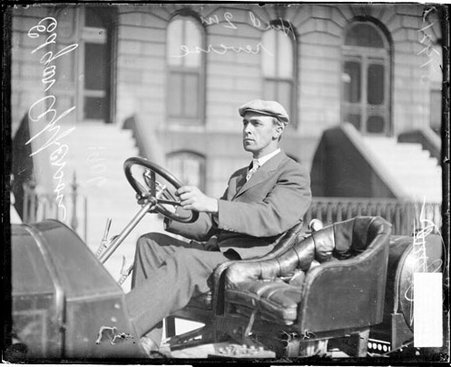 Edgar Apperson, a automobile driver, sitting in the driver's seat of an automobile parked - Chicago Daily News, Inc.