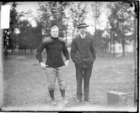 Football players J. McClurg and J. O. Watkins standing outdoors - Chicago Daily News, Inc.