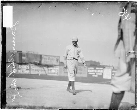 Baseball player Harry Davis, Philadelphia Athletics, walking in foul territory next to the first baseline - Chicago Daily News, Inc.