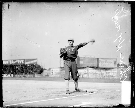 Baseball player Hal Chase, New York Highlanders, throwing a baseball, standing with one foot on first base - Chicago Daily News, Inc.