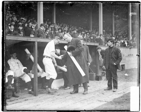 Cap Anson handing a box, probably containing a commemorative bat, to an unidentified Chicago Cubs baseball player - Chicago Daily News, Inc.